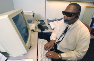 man using a screen reader in an office setting