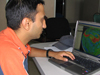 Adhikary studying a computer model that tracks forest fire emissions