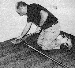 Figure 2. image of  a carpet layer using a power stretcher