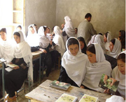 Anti-poppy notebooks being distributed in a girls school, Helmand Province. [State Dept. Photo]