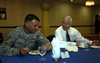 U.S. Defense Secretary Robert M. Gates, right, has breakfast with U.S. Air Force Tech. Sgt. Brian Rice, 36th Expeditionary Aircraft Maintenance Squadron,on Andersen Air Force Base in Guam, May 30, 2008.