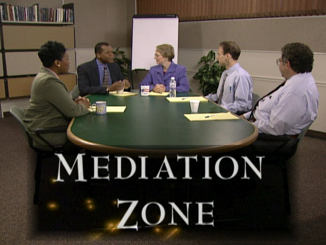Mediation Zone - Five people sitting around a large desk - This picture is linked to a 30 minute video