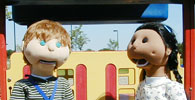 Two PACER puppets on a playground