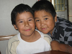 two native american boys smiling for the camera.