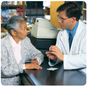 Pharmacist explaining details of a prescription medication to a customer.