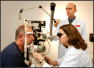 A client has his eyes examined by an optometry intern and optometrist Jeff Perotti