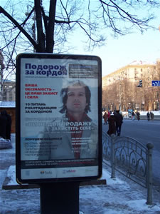 A poster of Vyacheslav Vakarchuk, an Okean Elzy front man, urges youth to get more information before traveling abroad