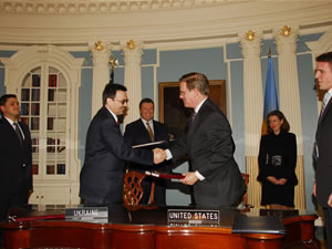 Volodymyr Makukha (left), Ukraine's Minister of the Economy, and Drew Luten (right), USAID's Acting Assistant Administrator for Europe & Eurasia, congratulate one another upon the signing of the $45 million Millennium Challenge Corporation Threshold agreement
