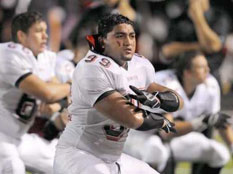 L.T. Tuipulotu (99) and his teammates on the Trinity Trojans perform the pre-game haka at Allen Eagle Stadium.  Credit: Scott Bjornlie/Trinity High