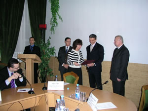 Earl Gast presents a certificate to a course graduate