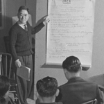 Japanese American man talks to a room of young people. Photo by Tom Parker.