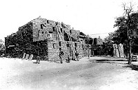 ARTISAN / DEMONSTRATORS POSING IN FRONT HOPI HOUSE. ELLE & TOM OF GANADO: CENTER. CIRCA 1910. GRAND CANYON N.P. MUSEUM COLLECTION.