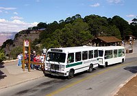 A NATURAL GAS POWERED SHUTTLE BUS AND TRAILER PICKING UP PASSENGERS AT THE HERMIT ROAD INTERCHANGE, GRAND CANYON N. P. NPS PHOTO. 