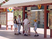 VISITORS TO GRAND CANYON N. P. VIEWING INFORMATIONAL DISPLAYS AT CANYON VIEW PLAZA. GIGI WRIGHT, NPS.