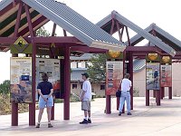 VISITORS TO GRAND CANYON N. P. VIEWING INFORMATIONAL DISPLAYS AT CANYON VIEW PLAZA. GIGI WRIGHT, NPS.