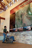 PARK VISITORS VIEWING LARGE MAPS AT CANYON VIEW PLAZA, THE VISITOR AND INFORMATION CENTER FOR GRAND CANYON N.P. NPS PHOTO.