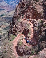 HIKERS DESCENDING STEEP SWITCHBACKS THROUGH THE REDWALL LIMESTONE ON THE BRIGHT ANGEL TRAIL - ABOVE INDIAN GARDENS. GRAND CANYON N. P. MIKE QUINN, NPS.