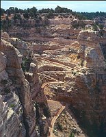 A MULE PARTY CLIMBS THE STEEP SWITCHBACKS THROUGH THE KAIBAB LIMESTONE ON THE SOUTH KAIBAB TRAIL. STEEP SWITCHBACKS DROP THROUGH THE ALMOST VERTICAL CHIMNEY AT THE HEAD OF SOUTH KAIBAB TRAIL. GRAND CANYON N.P. NPS PHOTO.