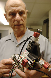 Principal Investigator Sam Floyd holds the device that will be used this summer when he and his team test the NUGGET concept.