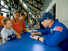 Astronaut Clay Anderson autographing