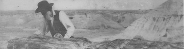 John Muir studying petrified log in Arizona.