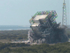 The mobile service tower on Cape Canaveral Air Force Station tumbles to the ground after implosion.