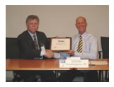 Dr. Richard Fenske receiving the Director’s Award plaque from NIOSH Director John Howard, M.D.