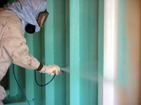 Worker spray painting in enclosed space increases fire hazard