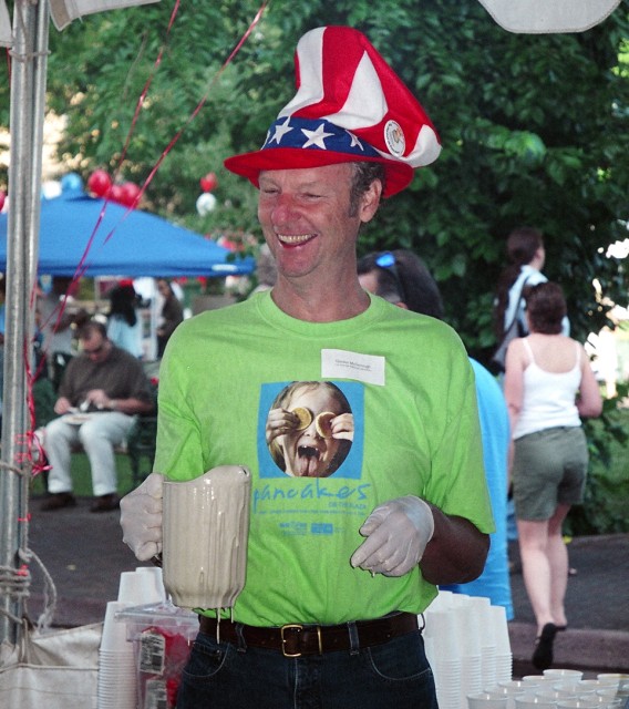 Gordon McDonough of the Bradbury Science Museum holds a carafe of pancake batter at last year's Pancakes on the Plaza community event. McDonough was one of about 60 Lab employees who volunteered to work the event.