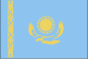 Flag of Kazakhstan is sky blue background representing the endless sky and a gold sun with 32 rays soaring above a golden steppe eagle in the center; on the hoist side is a 'national ornamentation' in gold.