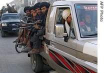 Taliban militants sit on their vehicle in the town of Musa Qala, 06 Nov 2007 (File photo)