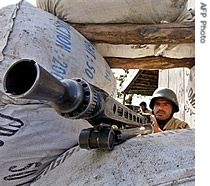 A Pakistani paramilitary soldier takes position at aroad side bunkers in Mingora, a town of the North West Frontier Province, 26 Oct 2007