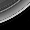 The Cassini spacecraft looks down from a high-inclination orbit to spot two of Saturn's ring moons