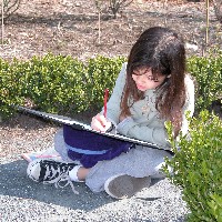 A young visitor completes an activity in the historic garden.