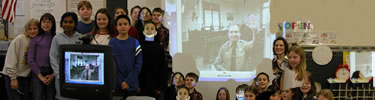 Students pose with a ranger from Ellis Island at the end of their electronic field trip to the park.