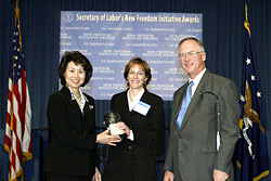 Secretary of Labor Elaine L. Chao (L) and Assistant Secretary of Labor for Disability Employment Policy Roy Grizzard (R) present a 2003 Secretary of Labors New Freedom Initiative Award to Diane J. Gherson, Vice President, Compensation and Benefits, IBM.  (DOL Photo/Shawn Moore)