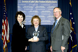 Secretary of Labor Elaine L. Chao (L) and Assistant Secretary of Labor for Disability Employment Policy Roy Grizzard (R) present a 2003 Secretary of Labors New Freedom Initiative Award to Joyce A. Bender of Bender and Associates International, Inc. (DOL Photo/Shawn Moore)