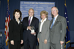 Secretary of Labor Elaine L. Chao (L) and Assistant Secretary of Labor for Disability Employment Policy Roy Grizzard (R) present a 2003 Secretary of Labors New Freedom Initiative Award to Edmund L. Cortez, President/CEO, Abilities, Inc., and Francine M. Tishman, Executive Director/COO, Abilities, Inc. (DOL Photo/Shawn Moore)