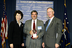 Secretary of Labor Elaine L. Chao (L) and Assistant Secretary of Labor for Disability Employment Policy Roy Grizzard (R) present a 2003 Secretary of Labors New Freedom Initiative Award to Dale Giovengo, Human Resources Director, Giant Eagle, Inc.  (DOL Photo/Shawn Moore)