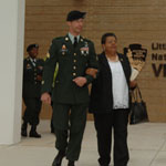 U.S. Army paratrooper escorts Elizabeth Eckford to the stage for dedication ceremony.