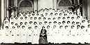 Clara Barton seated with a female nurses graduation class.