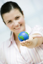 Female student holding the world in her hand.