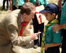 Photo: Ambassador William Brownfield introduces himself to a young member of the Scouts Association of Venezuela and recounts his days as a Boy Scout.