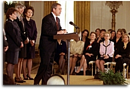President Bush speaks to women business leaders in the East Room of the White House. Also pictured are Cabinet Secretaries: Secretary of Agriculture Ann Veneman, Secretary of the Interior Gale Norton and Secretary of Labor Elaine Chao.