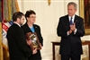 President George W. Bush leads the applause to honor U.S. Army Pfc. Ross A. McGinnis after presenting the Congressional Medal of Honor posthumously to his parents, Tom and Romayne McGinnis, of Knox, Pa., June 2, 2008, at the White House.  