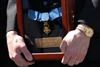Tom McGinnis, father of Medal of Honor recipient Army Pfc.. Ross McGinnis, who received the award posthumously, displayed his son's medal with pride following a White House ceremony, June 2, 2008. 