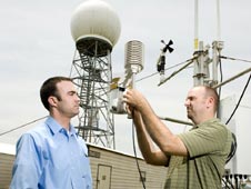 Kevin McGrath, terrestrial environments engineer in the Marshall Engineering Directorate, and Barry Roberts at an Army weather station on Redstone Arsenal.