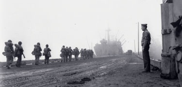 Allied troops file towards their transport vessel, bound for Japanese-held Attu Island in May, 1943