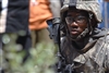 U.S. Army Sgt. Dajuan Turner maintains security outside a school where Iraqi men are signing up for a local neighborhood watch program in the Sadr City district of Baghdad, Iraq, May 30, 2008.