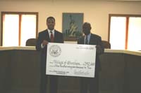 Congressman Jackson Mayor Robert Polk displaying a giant check to the Village of Burnham for $392,000